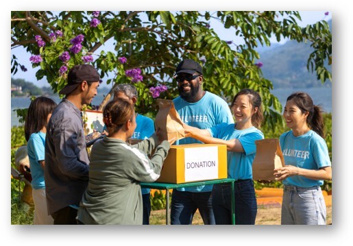 Nonprofit volunteers working together at a community event, representing mission-based silent auction ideas that connect donors to a charity's cause