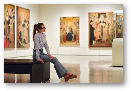 Art museum gallery with sculptures and paintings, representing exclusive VIP experience silent auction items for nonprofit galas